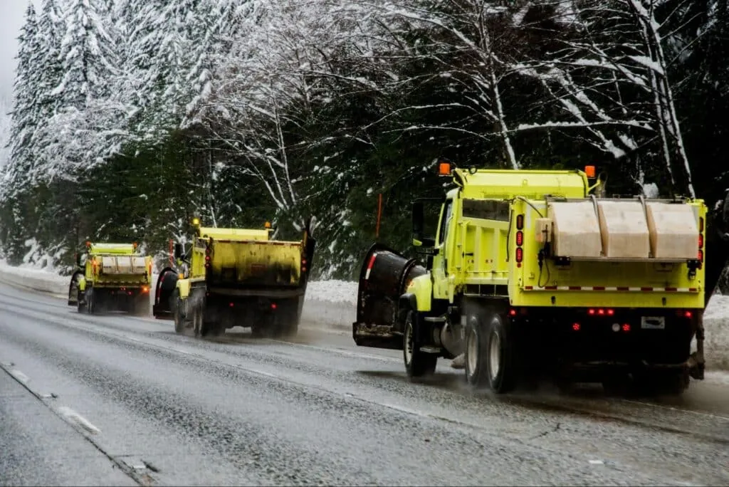 Snowplows clearing roads to ensure winter travel safety and accessibility.