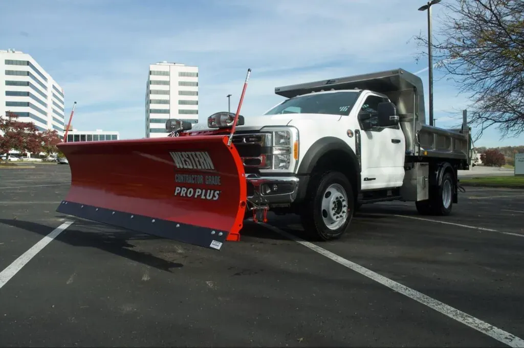 Snow removal truck with plow prepared for winter conditions.