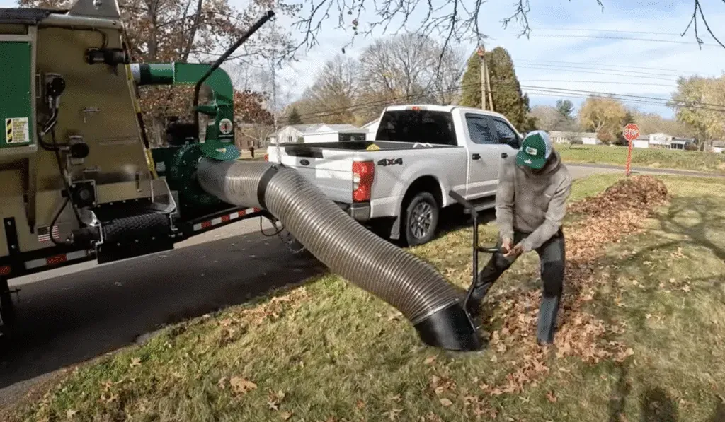 Effortless autumn leaf collection with innovative machinery in action.