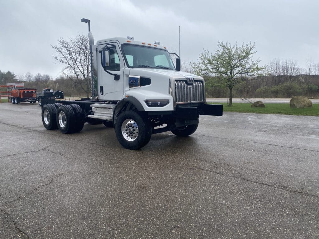 Western Star heavy-duty tandem axle truck parked on a wet driveway.