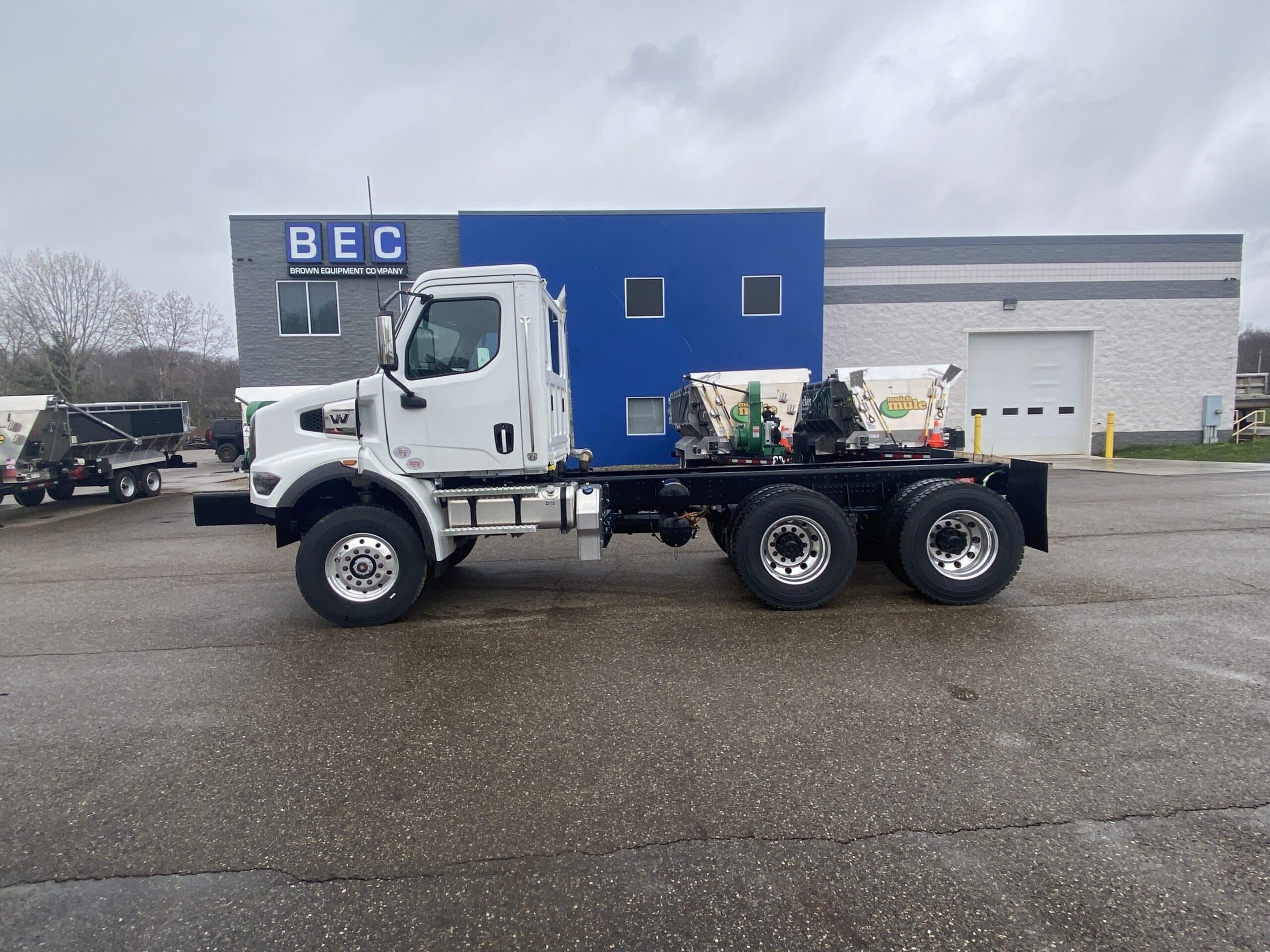 White Western Star truck with tandem axles parked at equipment company.