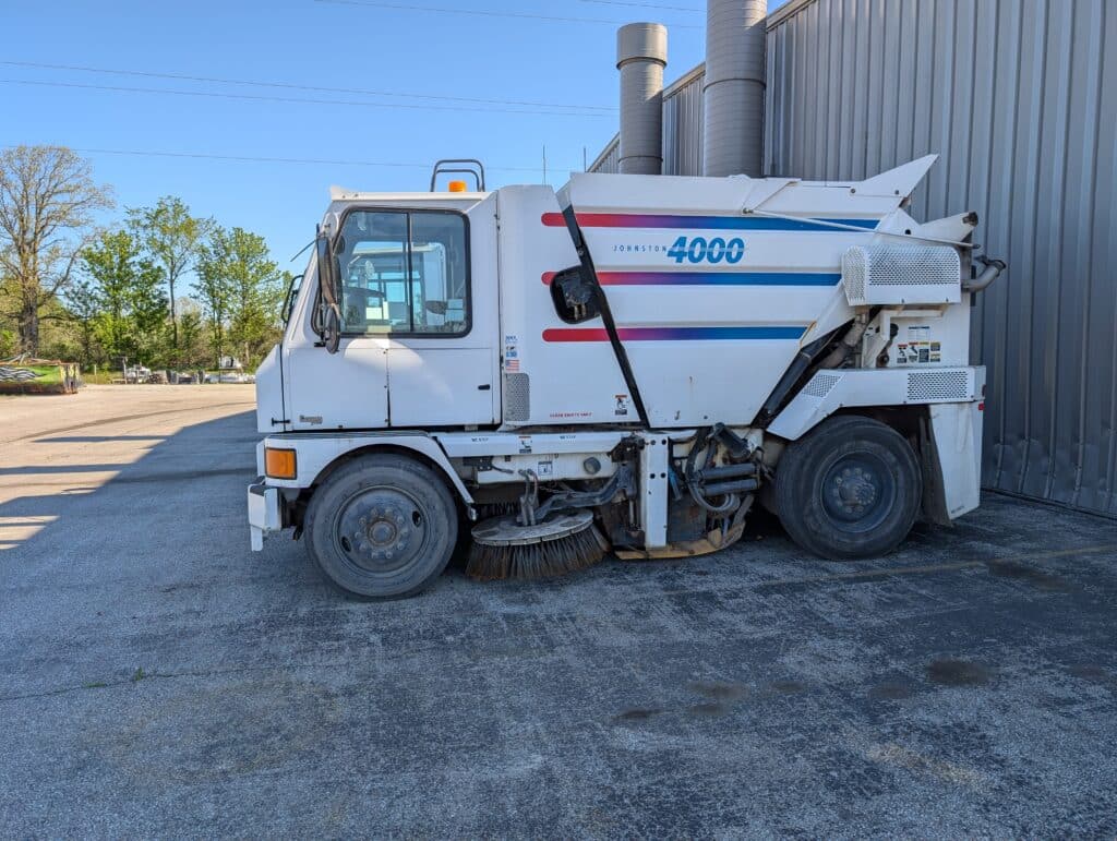 Used Johnston 4000 street sweeper parked for sale in inventory.