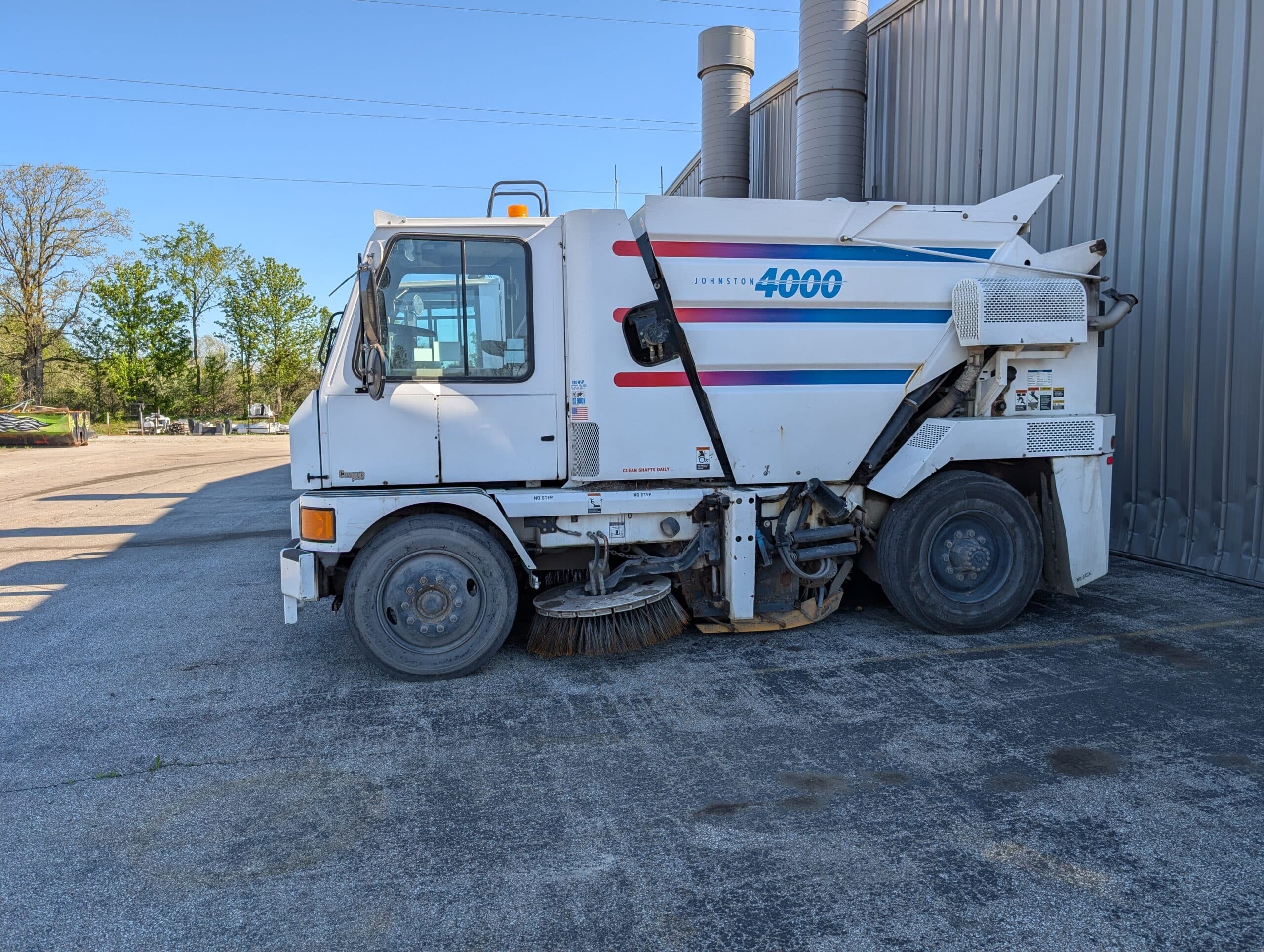 Used Johnston 4000 street sweeper parked for sale in inventory.