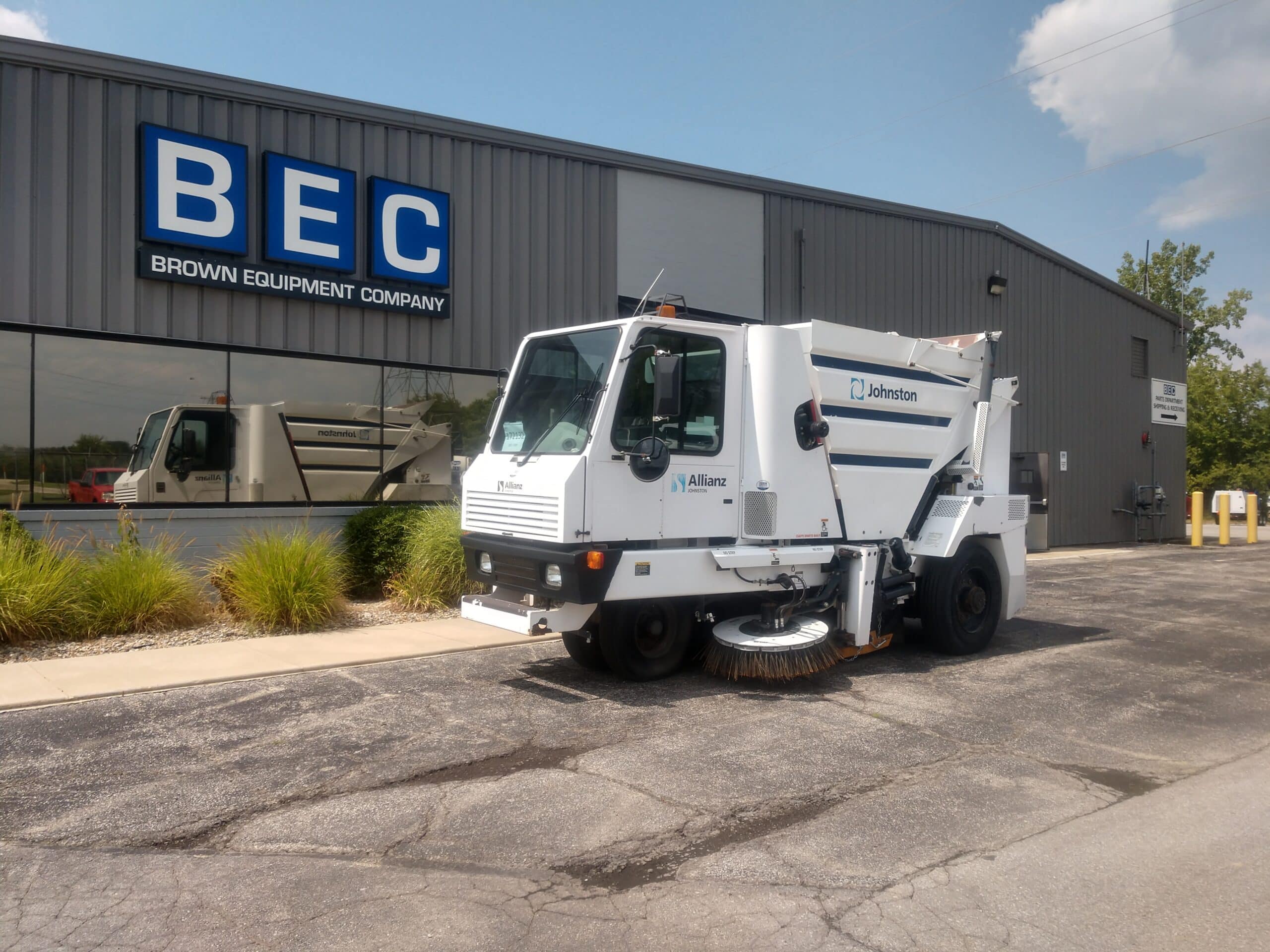 Johnston street sweeper parked outside Brown Equipment Company for slow-moving inventory.
