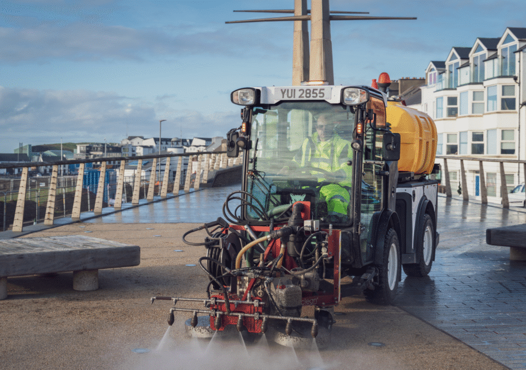Street sweeping vehicle sanitizing the boardwalk