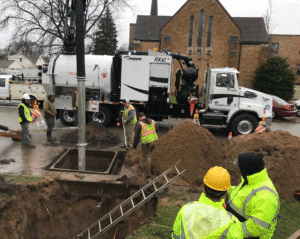 Construction crew working on a site, operating machinery and managing excavation.