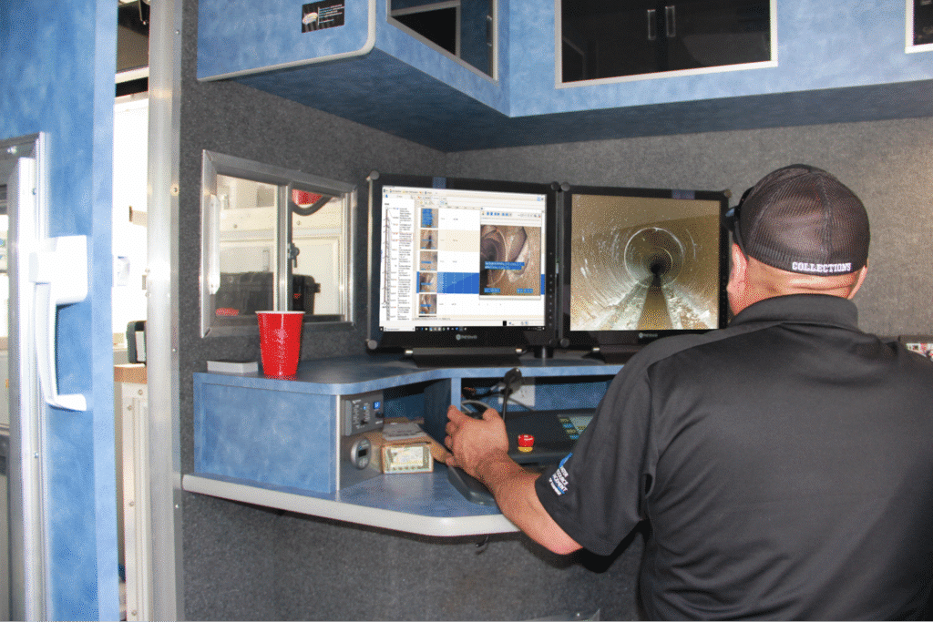 Technician operating pipeline inspection system in mobile station.