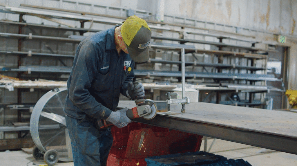 Metalworker using precision tools to ensure safety and skill in metal fabrication.
