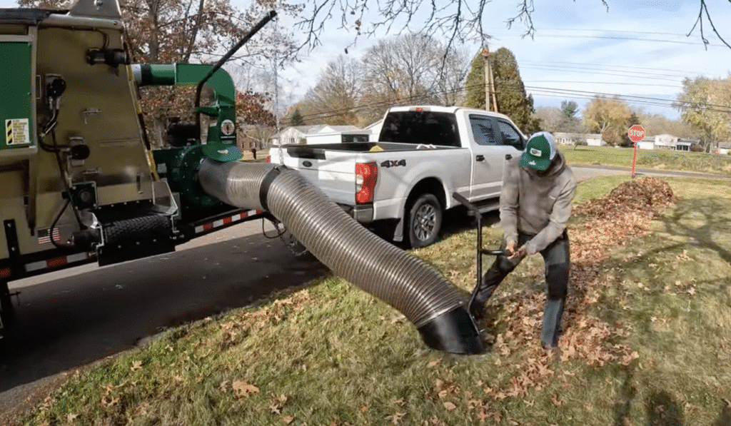 Effortless autumn leaf collection with innovative machinery in action.