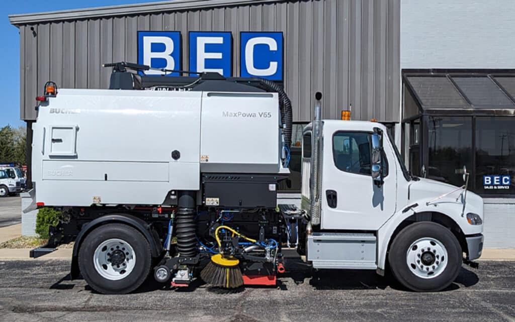 Street sweeper vehicle actively maintaining urban cleanliness and sanitation.