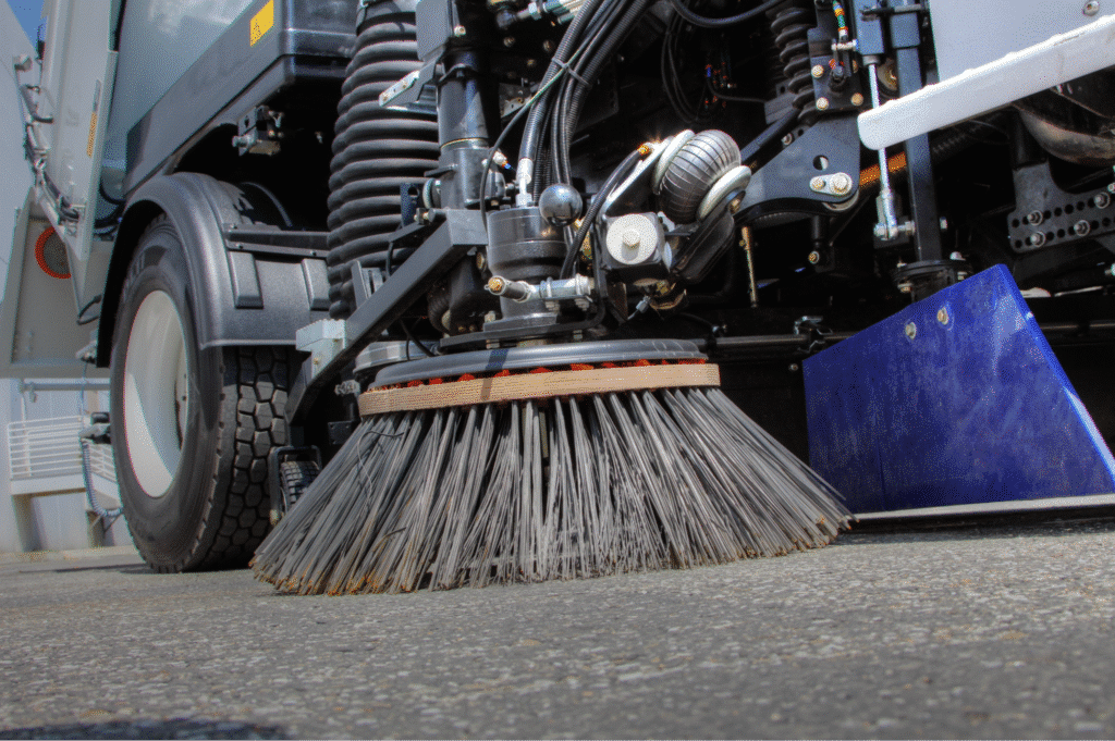 Street cleaning brush efficiently removing debris from city streets.