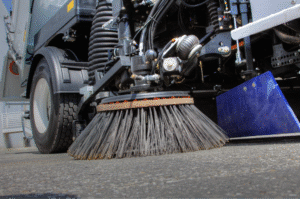 Street cleaning brush efficiently removing debris from city streets.