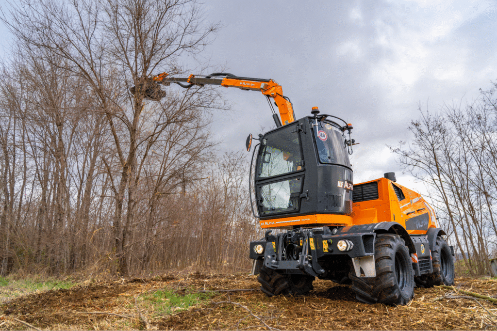 Land clearing tree removal machine efficiently clearing trees in a wooded area.