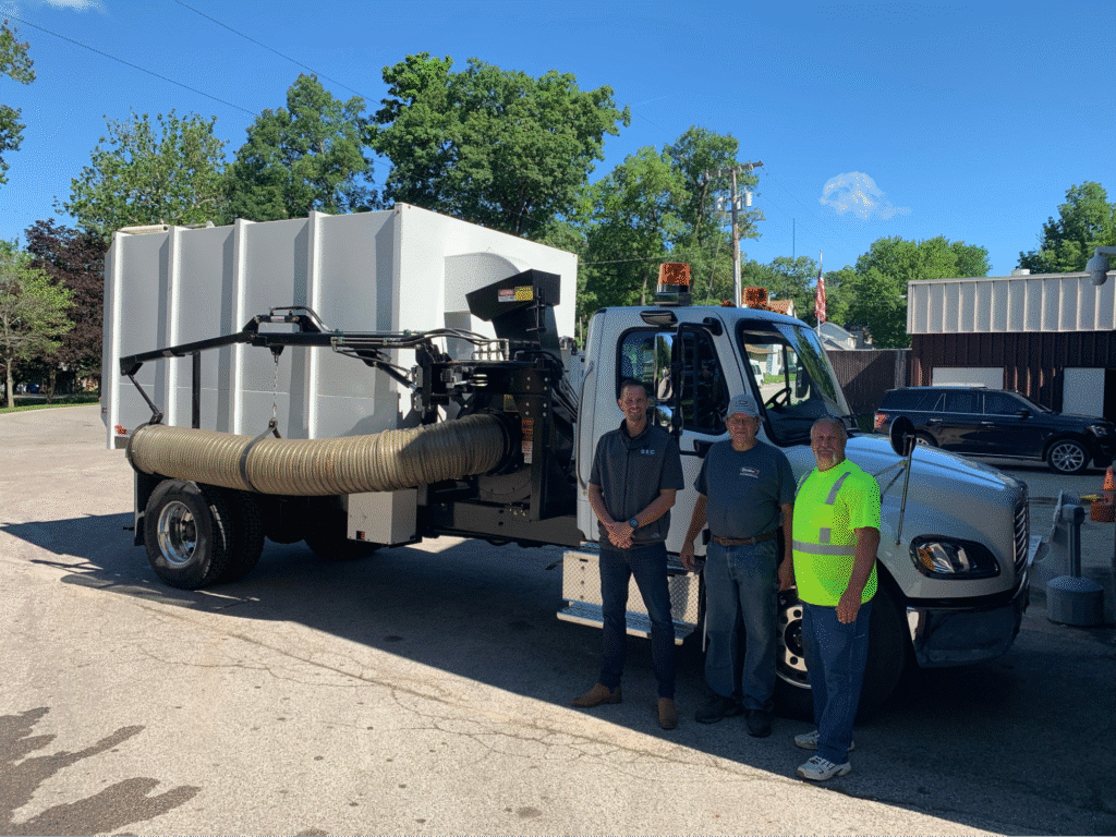 Team stands by leaf cleanup truck