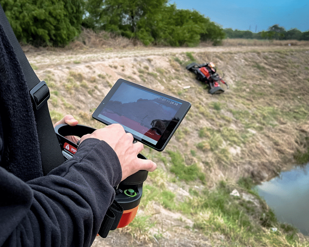 Operating a remote slope mowers on uneven terrain using a handheld device.