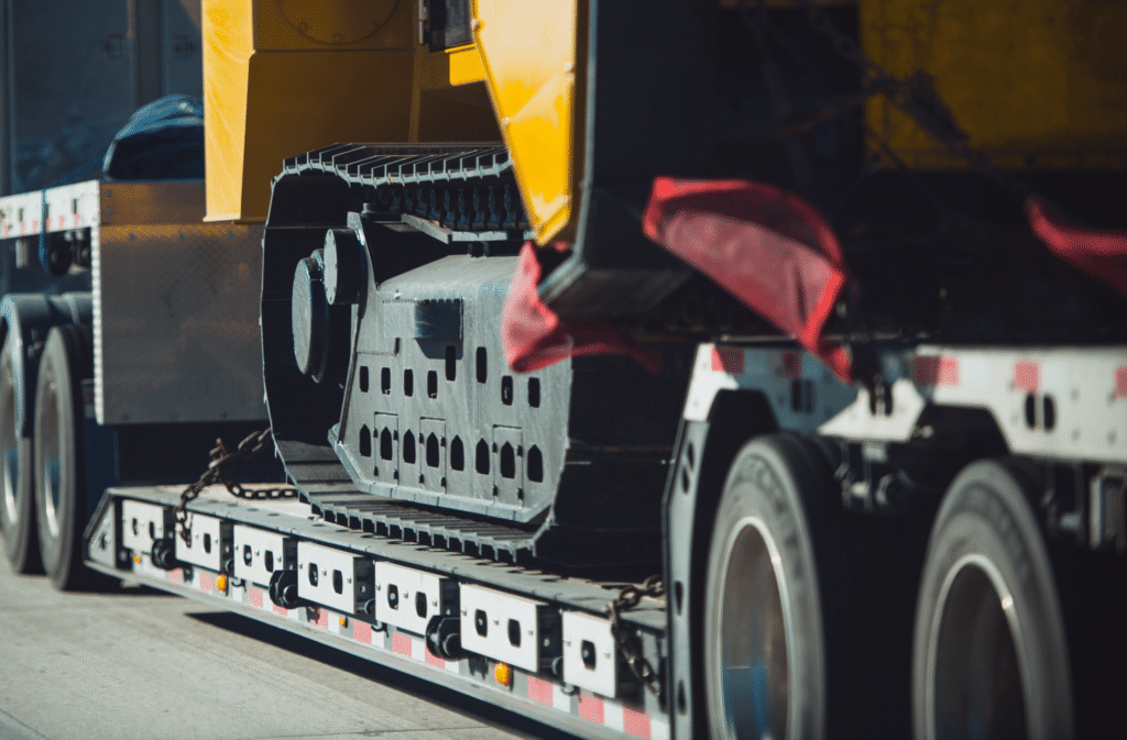 Heavy-duty trailer transporting industrial equipment on road.