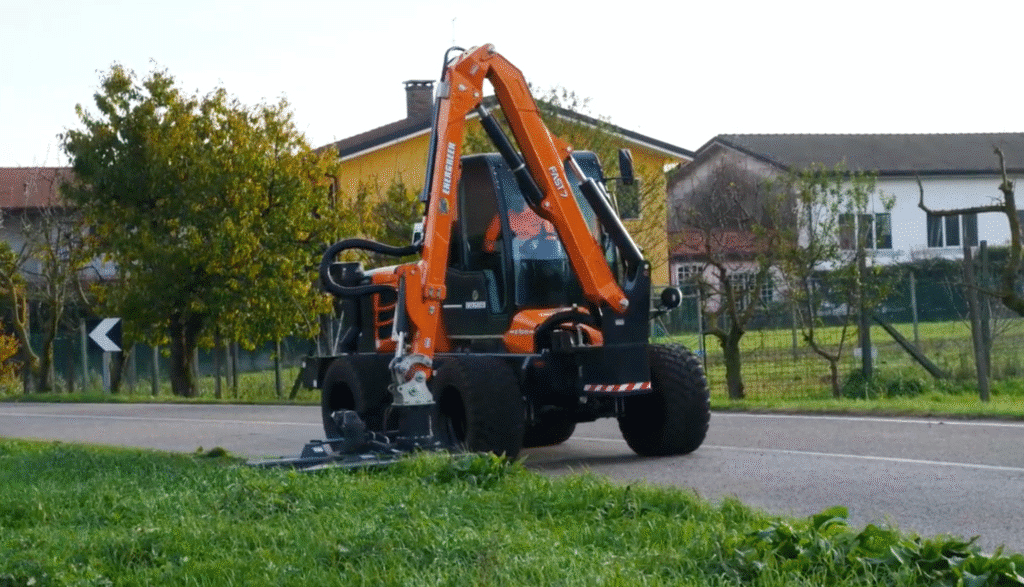 Compact remote control tool carrier along a roadside in a scenic environment.