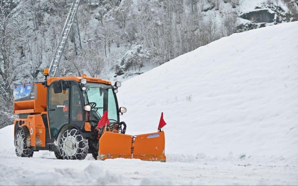 Snow plow clearing a winter landscape covered in fresh snow conveying winter preparation for municipalities concept