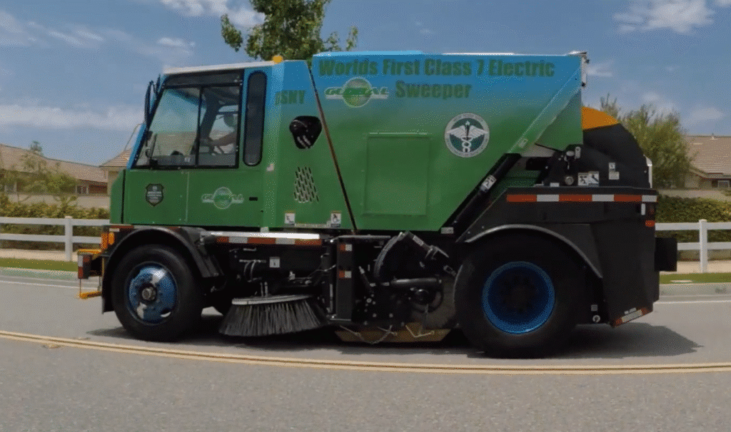 Electric street sweeper showcasing eco-friendly cleaning technology on city roads.