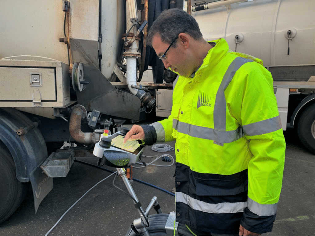 iBAK worker pipeline inspecting camera equipment on a truck in safety gear for maintenance and quality assurance.