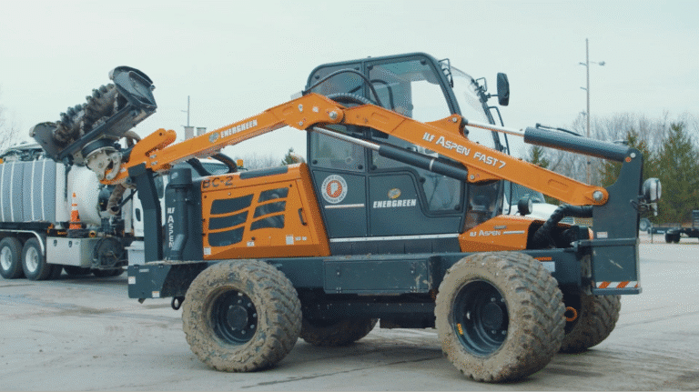Heavy-duty skid steer loader lifting equipment at a construction site for efficient material handling.