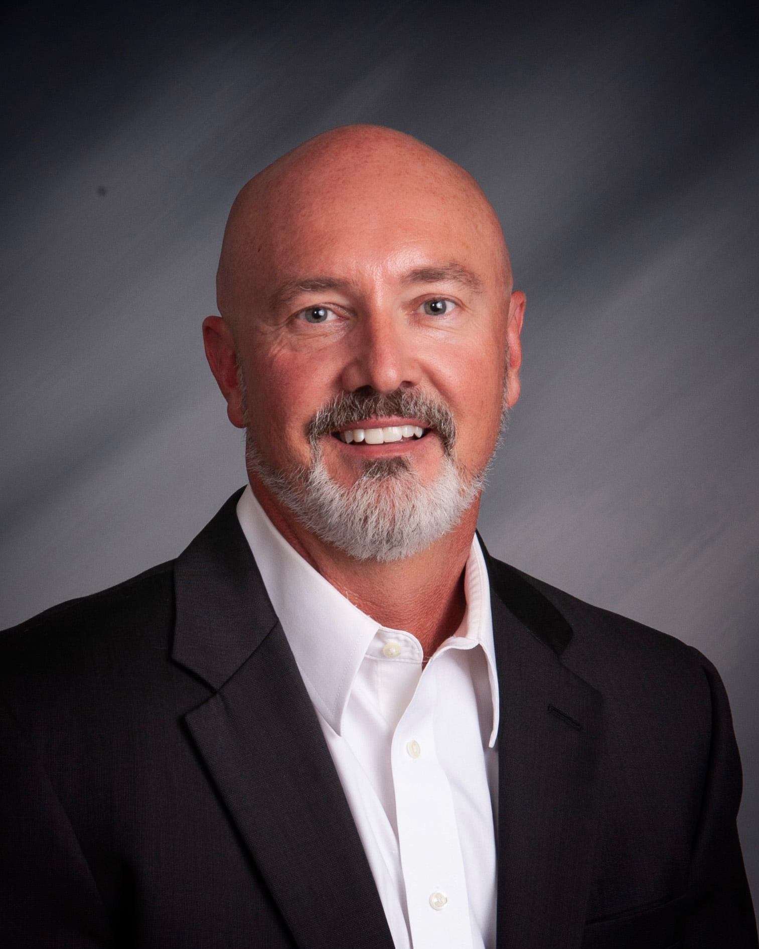 Executive professional portrait showcasing confidence and approachability in business attire.