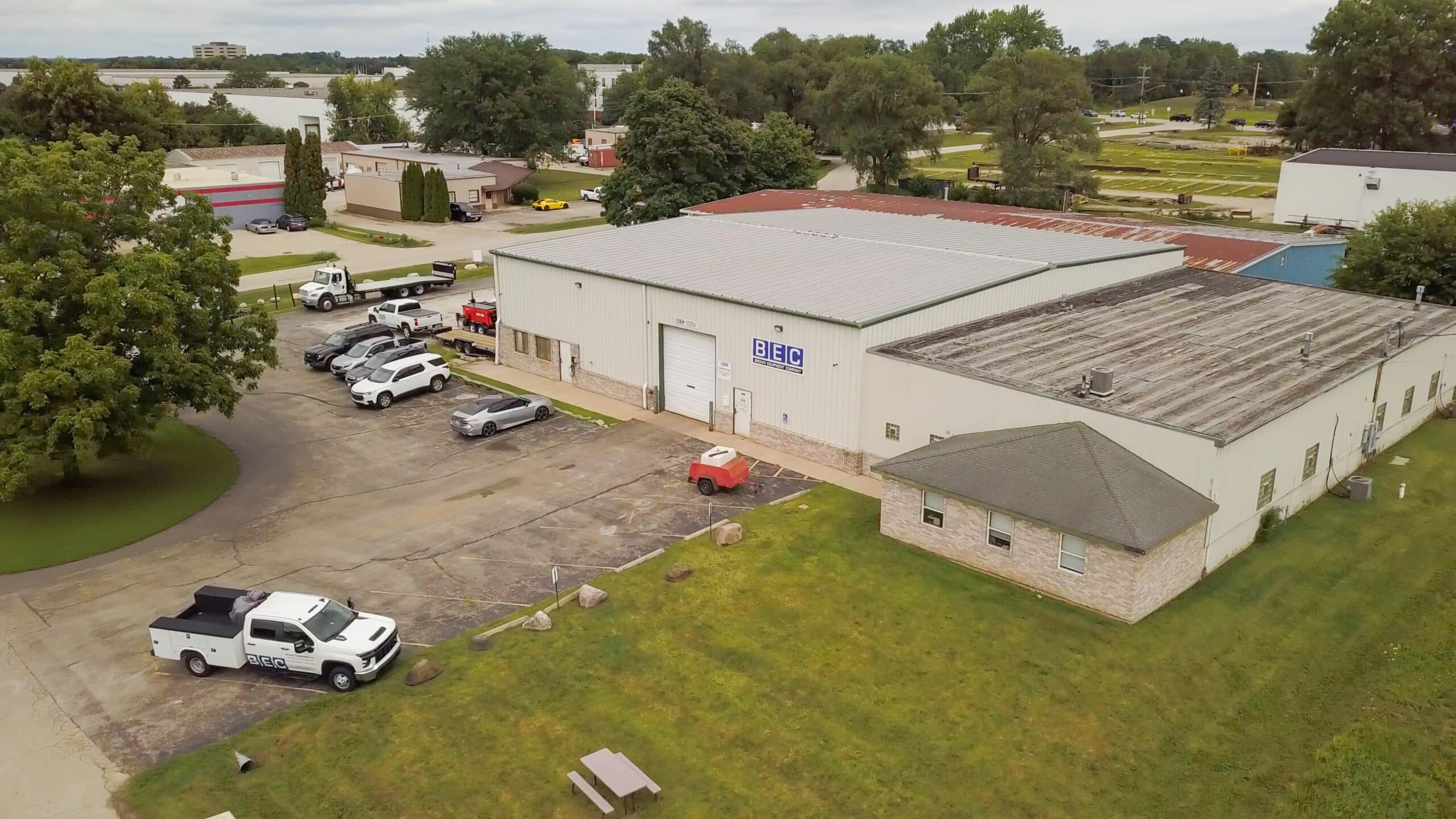 Aerial view of the BEC Chicago Service Center building with parking and surrounding greenery.