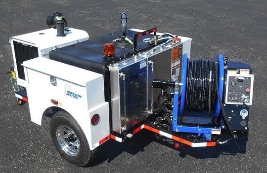 Mongoose Jetters trailer with high-pressure jetting system for efficient sewer cleaning.