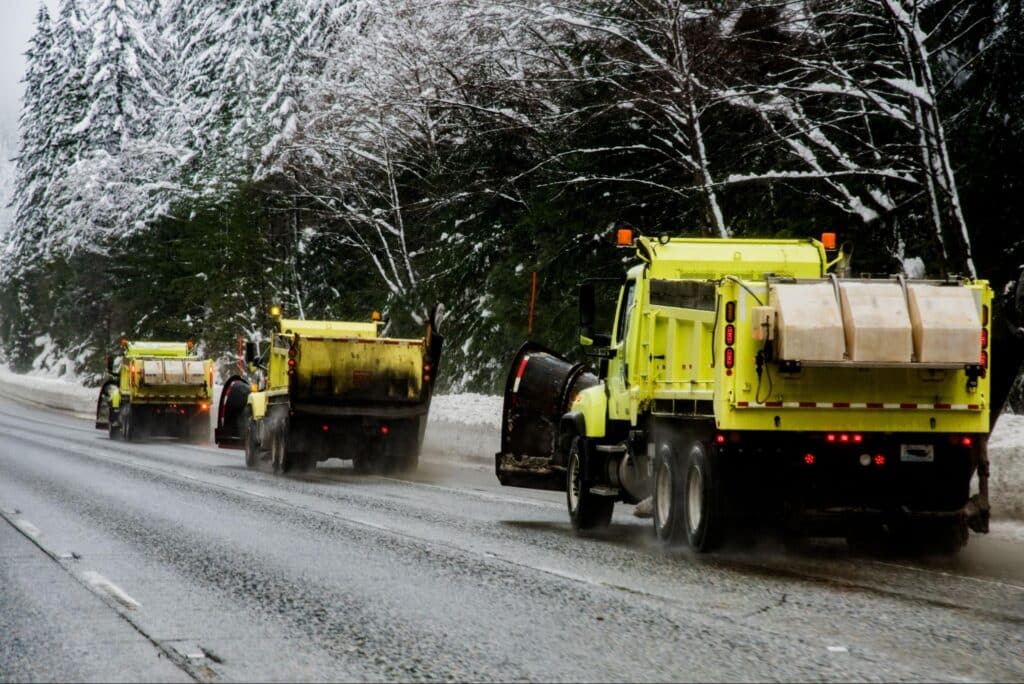 Snowplows clearing roads to ensure winter travel safety and accessibility.