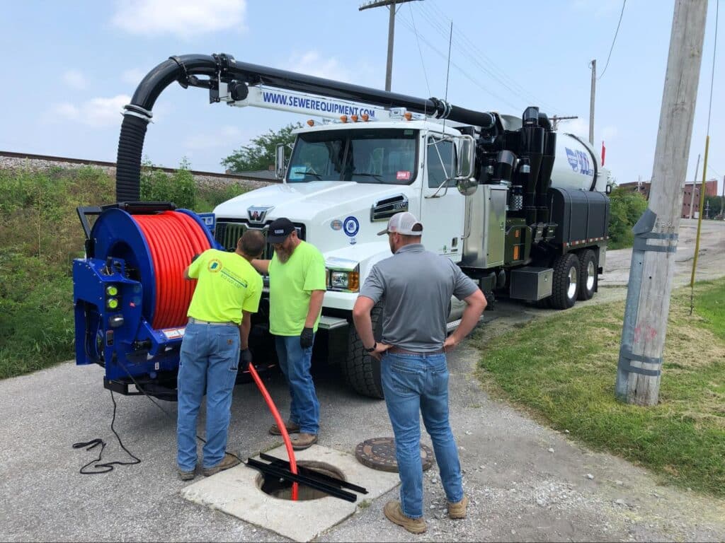 Sewer maintenance team using a vacuum truck for effective inspection and cleaning.