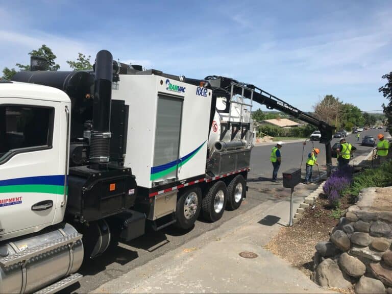 Hydro excavation truck assisting road maintenance crew in efficient utility repairs.