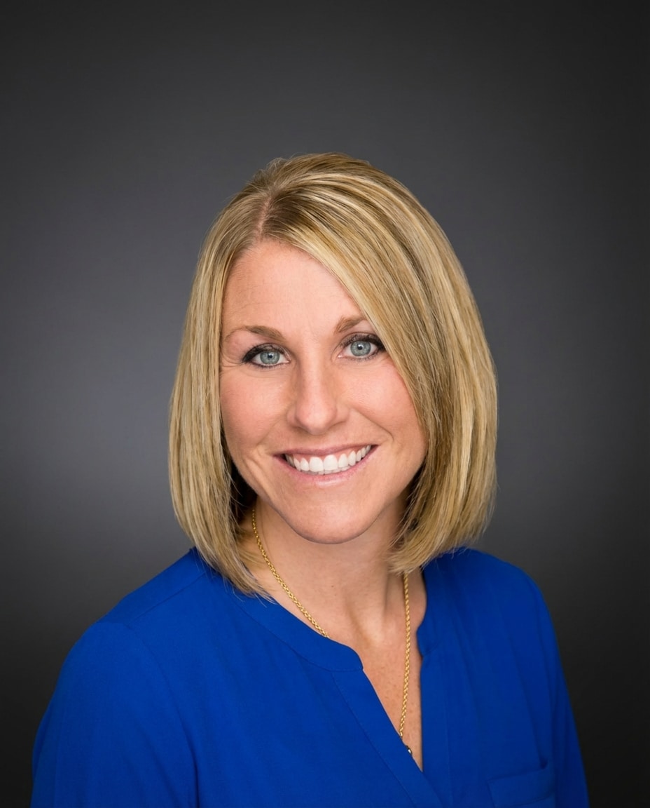 Megan Ainscough, Marketing and Sales Expert, smiling in a blue shirt.