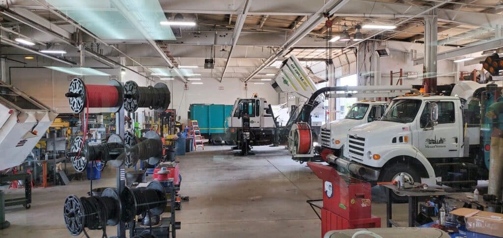 Brown Equipment Service Center with trucks and machinery in action.