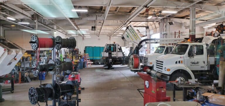 Brown Equipment Service Center with trucks and machinery in action.