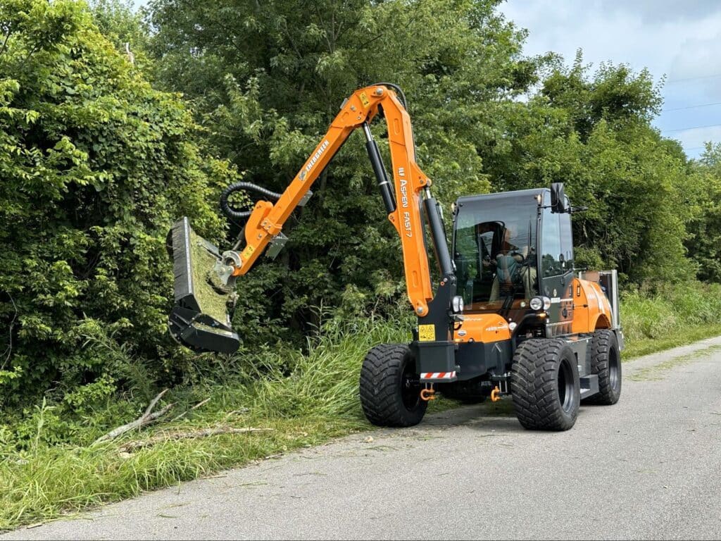 Heavy machinery efficiently clearing roadside brush for safety and maintenance.