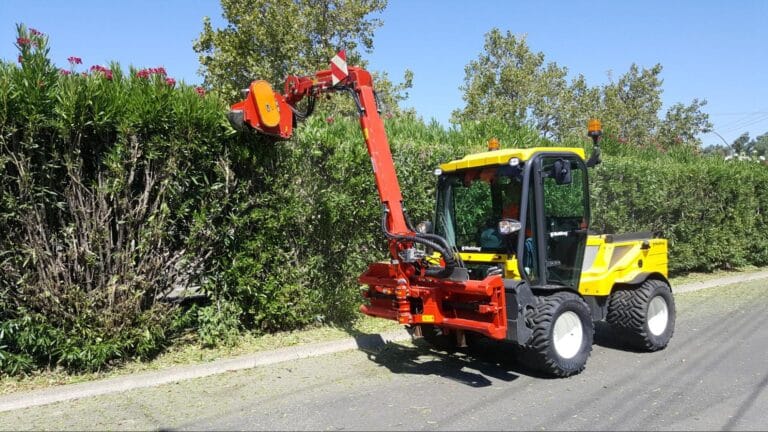 Efficient hedge maintenance with specialized trimming vehicle in landscaped area.