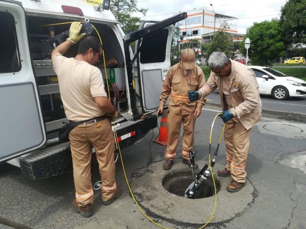 Technicians conducting utility inspections using advanced IBAK equipment on-site.