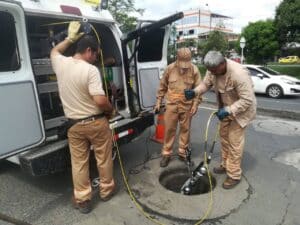 Technicians conducting utility inspections using advanced IBAK equipment on-site.