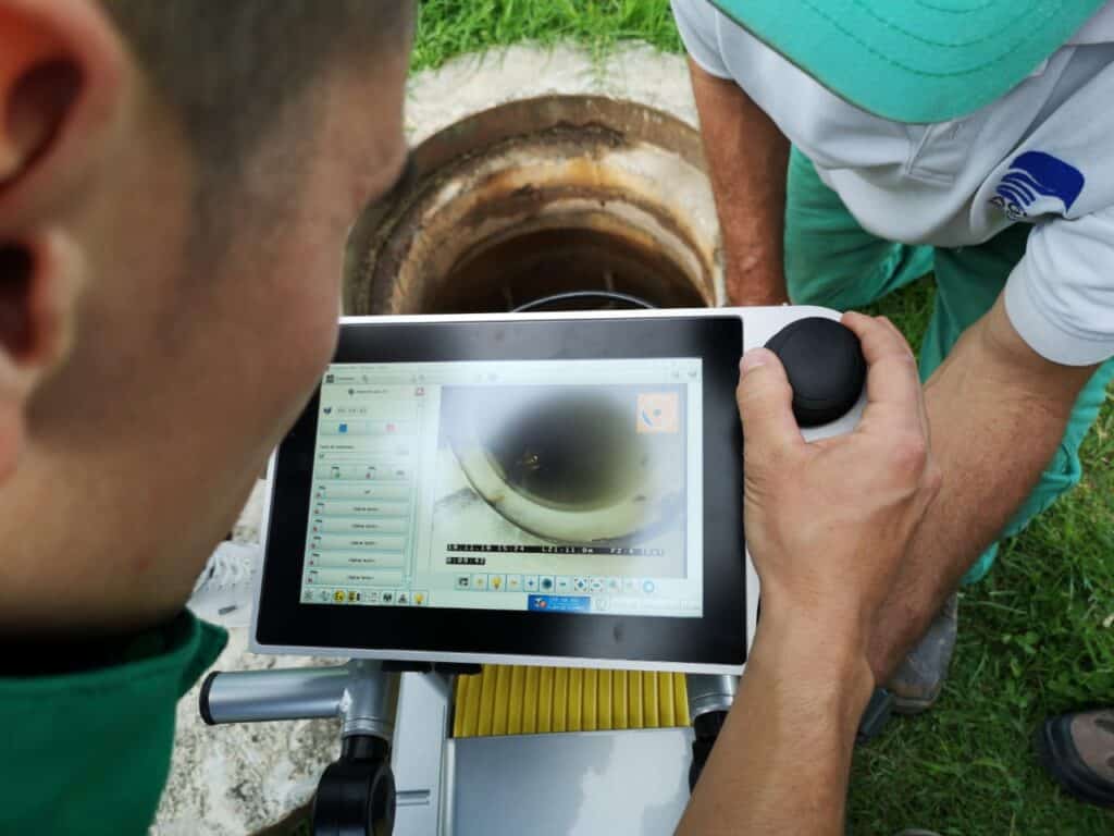 Technicians using IBAK technology to inspect underground sewer systems efficiently.