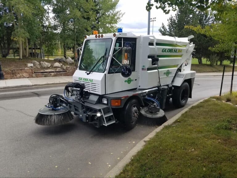 Urban street sweeper improving fall cleanliness on city roads.