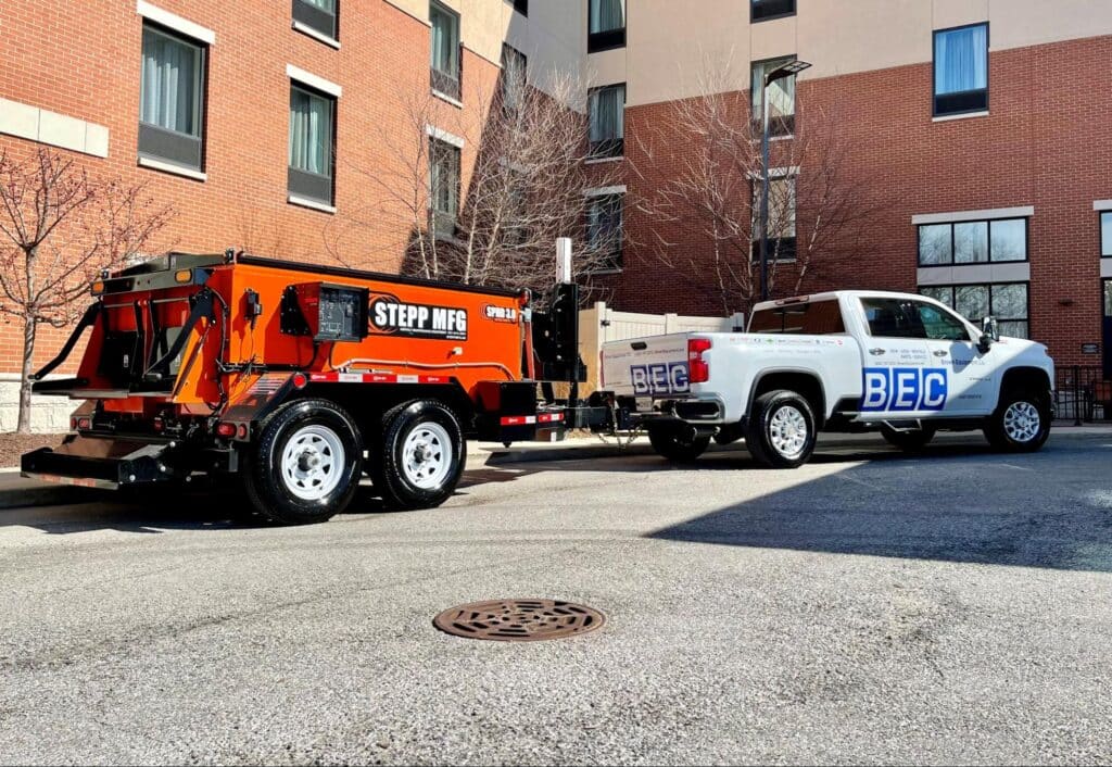 Construction vehicles parked near a building, showcasing urban construction equipment in action.