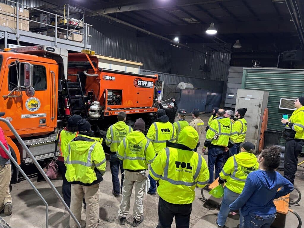 Hot box operator trainees learn equipment operations in a warehouse environment.