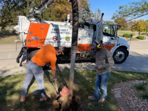Hydrovac team conducts essential repairs in a residential area with advanced equipment.