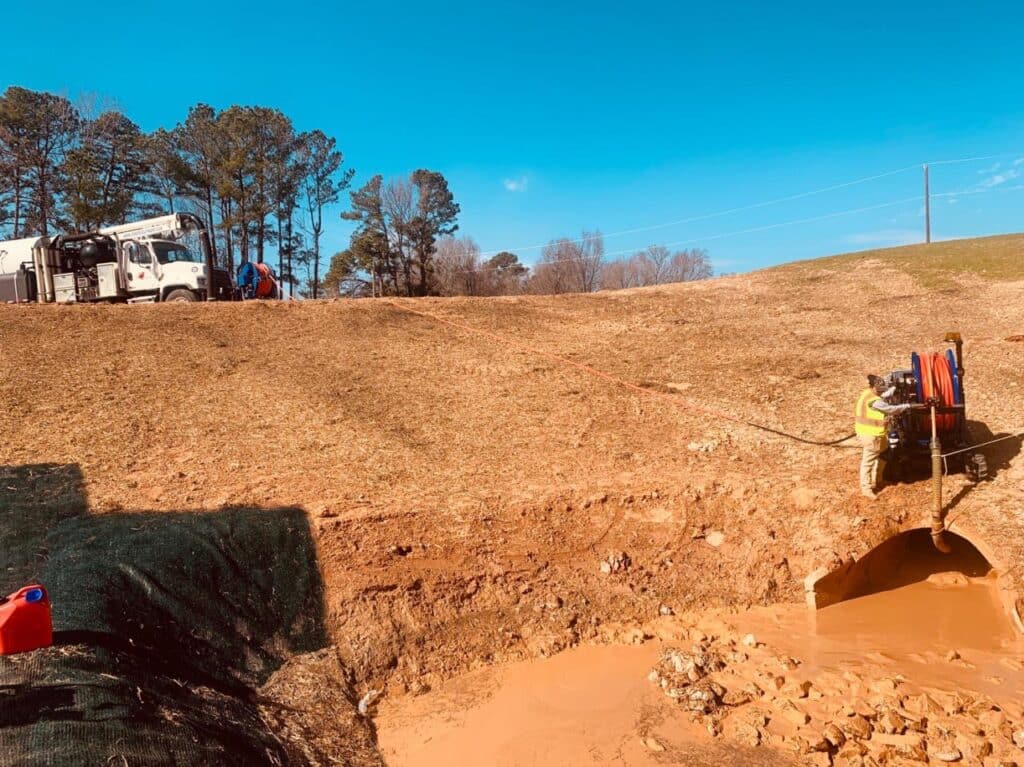 Easement machine maintenance on a sunny day in a rural landscape.