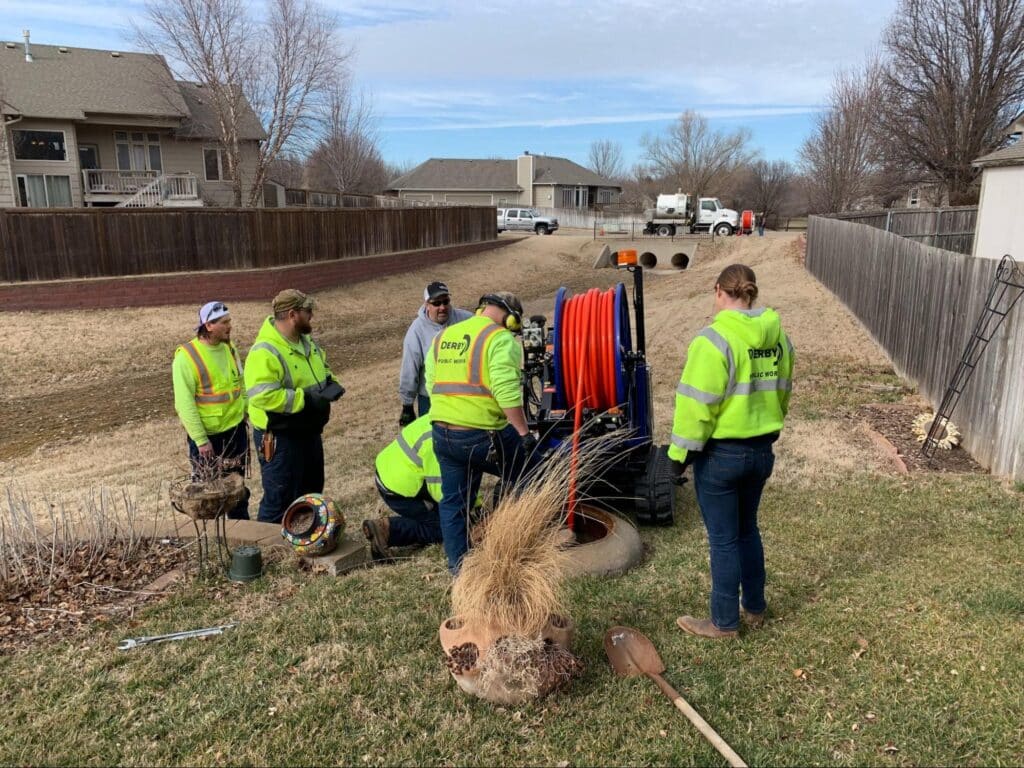 Utility workers in safety gear collaborating to improve community infrastructure.