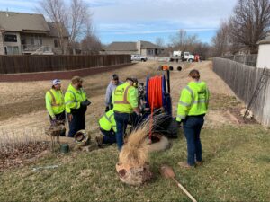 Utility workers in safety gear collaborating to improve community infrastructure.